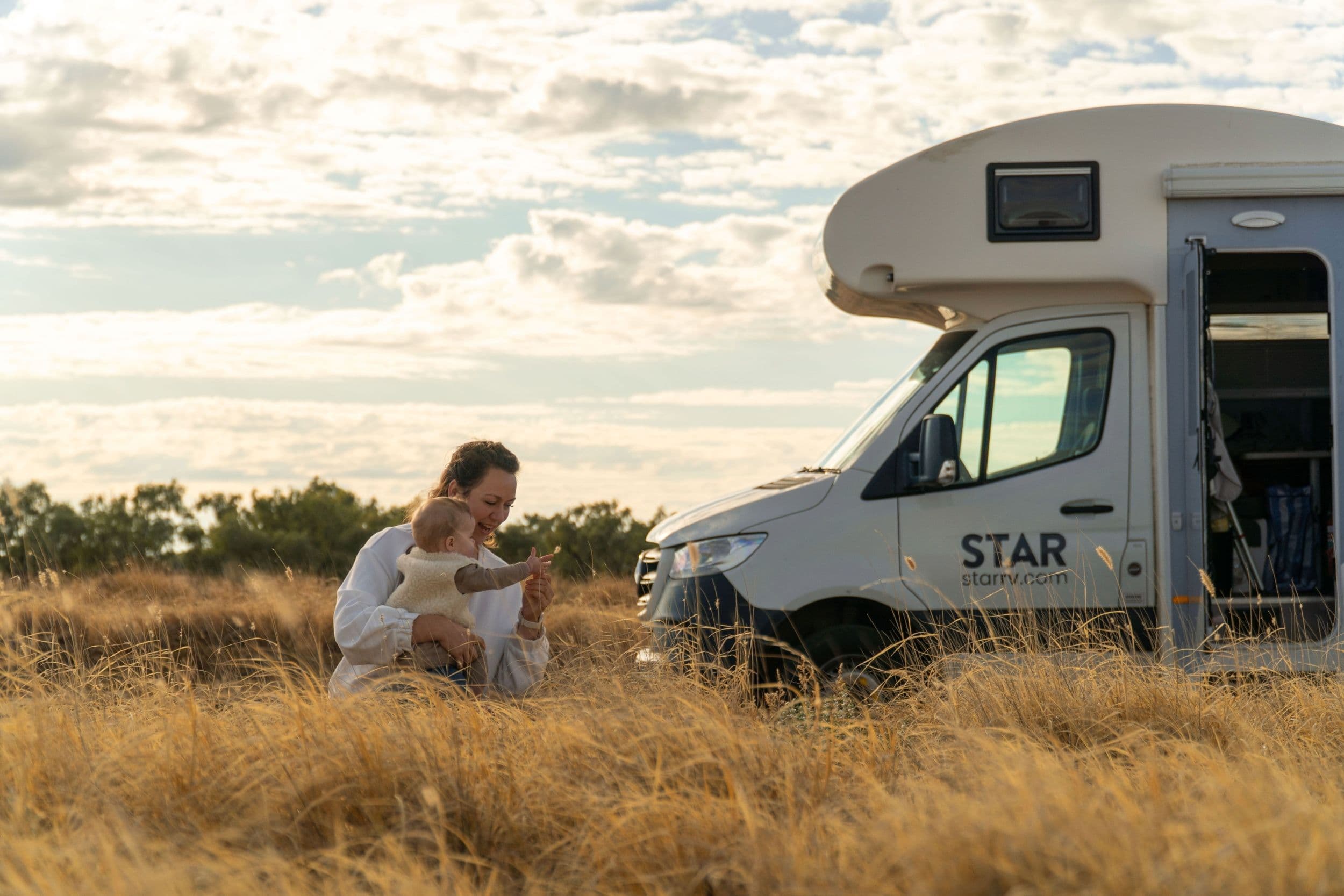 Mom playing with a baby in front of Star RV Polaris 6
